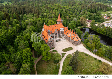 Cesvaine medieval castle in Latvia from above. Building of stones with a brown tiled roof. Cesvaine medieval castle in Latvia from above. Building of stones with a brown tiled roof. 132336560