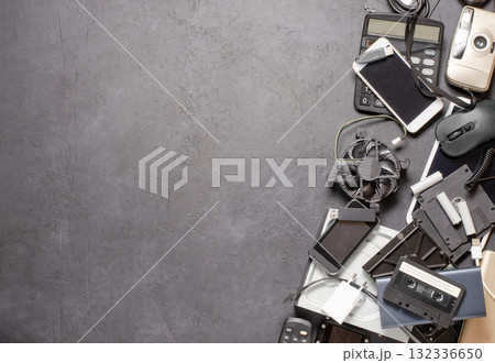 Old electronic devices on a black background. The concept of recycling used gadgets. Copy space Old electronic devices on a black background. The concept of recycling used gadgets. Copy space 132336650