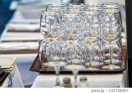 stacks of clean empty glasses on trays in a street cafe, closeup 132336867