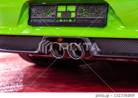 close-up of modern sporty car dual exhaust pipes, vehicle smog polluting the air 132336869