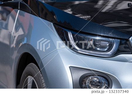 a row of cars parked on the side of the street, closeup of body elements and headlights 132337340