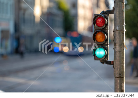 view of city traffic with traffic lights, in the foreground a semaphore with a green light, closeup view of city traffic with traffic lights, in the foreground a semaphore with a green light, closeup 132337344
