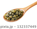 Pickled capers in a wooden spoon on a white background. Isolated 132337449
