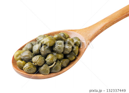 Pickled capers in a wooden spoon on a white background. Isolated Pickled capers in a wooden spoon on a white background. Isolated 132337449
