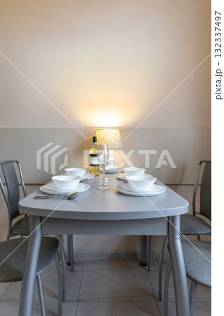 Cozy Minimalist Dining Table with Lamp and White Tableware 132337497