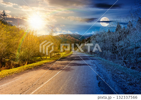 road through mountain landscape on autumn equinox. day and night time change concept. forest in fall colors under sky with sun and moon. snow covered peak in the distance. scenic view rural valley road through mountain landscape on autumn equinox. day and night time change concept. forest in fall colors under sky with sun and moon. snow covered peak in the distance. scenic view rural valley 132337566
