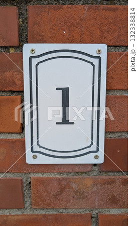 House Number One elegantly displayed on a classic Brick Wall, showcasing unique architecture House Number One elegantly displayed on a classic Brick Wall, showcasing unique architecture 132338814