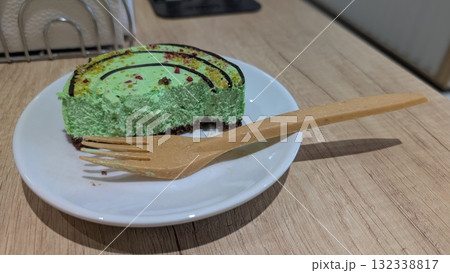 A Beautiful and Delicious Green Dessert Plated Elegantly Alongside a Wooden Fork A Beautiful and Delicious Green Dessert Plated Elegantly Alongside a Wooden Fork 132338817