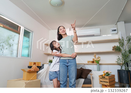 Celebrating new beginnings. Mother and daughter in their new home. 132339267