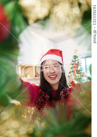 Festive Joy. Young woman celebrating Christmas with a joyful smile. Festive Joy. Young woman celebrating Christmas with a joyful smile. 132339291