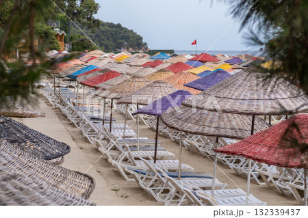 Colorful beach umbrellas line the sandy shore at Prince Islands creating a vibrant vacation atmosphere on a sunny day 132339437
