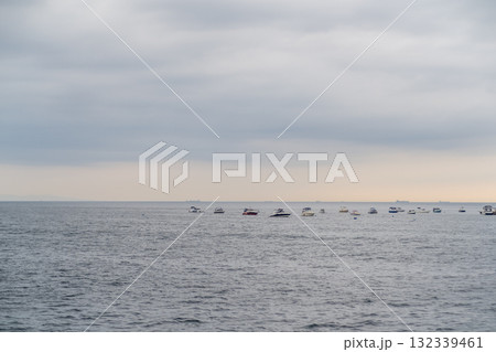 Serene view of Prince Islands with boats floating gracefully on calm waters during a cloudy day 132339461