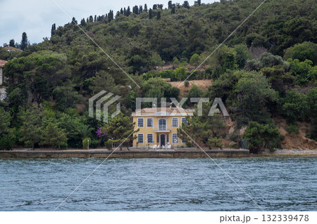 Exploring a charming villa on the coastline of Prince Islands surrounded by lush greenery on a cloudy day Exploring a charming villa on the coastline of Prince Islands surrounded by lush greenery on a cloudy day 132339478