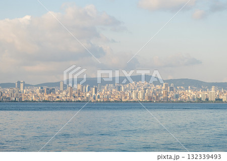 Views of the modern skyline of an island town surrounded by calm waters and distant mountains in Prince Islands during a clear day 132339493