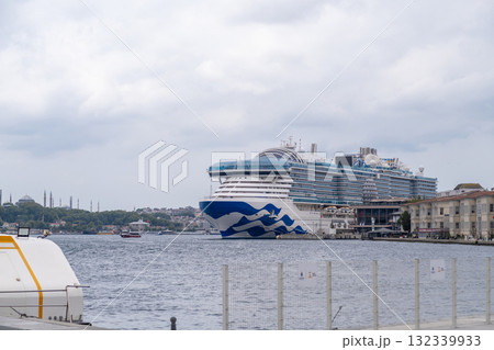 Cruise ship docked in the Bosphorus with Istanbul skyline in the background during an overcast day 132339933