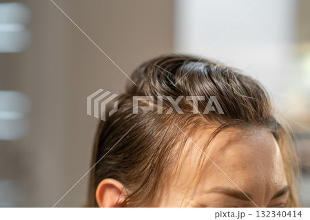 Color changing process of hair observed during a salon appointment in a modern studio setting 132340414