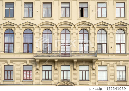 Architectural details of a historic building in Saint Petersburg showcasing elegant design and large windows during daylight 132341089