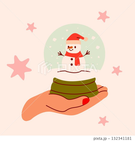 Christmas snow globe with snowman inside held by hand 132341181