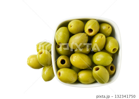 Ceramic bowl with pickled pitted green olives isolated on a white background, top view. Ceramic bowl with pickled pitted green olives isolated on a white background, top view. 132341750