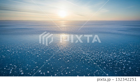 Frozen Lake Reflecting Golden Sunlight at Sunset With Horizon 132342251