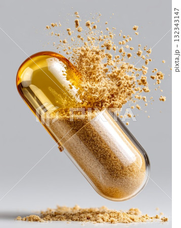 Golden oil capsule bursting open revealing fine powder, symbolizing isolation and exclusion 132343147