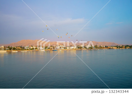 Hot air balloons over Luxor West Bank at sunrise from the Nile River. Hot air balloons over Luxor West Bank at sunrise from the Nile River. 132343344
