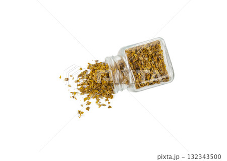 Mullein or Verbascum dried flowers pouring from a glass jar isolated on white background. Used in herbal medicine 132343500
