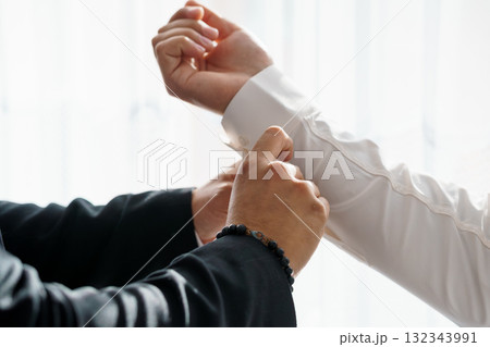 Business Negotiation Handshake Agreement Dark Suit, White Shirt, Black Bracelet, Formal Attire, Close-Up, Successful Deal, Trust, Partnership. 132343991