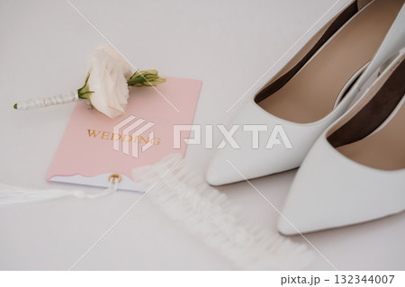 Elegant White Wedding Shoes with Rose Boutonniere and Card Bridal Accessories, Romantic Celebration, Soft Pastel Theme, Delicate Details Elegant White Wedding Shoes with Rose Boutonniere and Card Bridal Accessories, Romantic Celebration, Soft Pastel Theme, Delicate Details 132344007