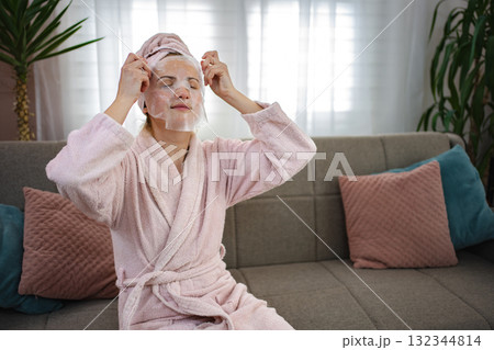 Young Woman Applying Cosmetic Face Mask at Home Young Woman Applying Cosmetic Face Mask at Home 132344814