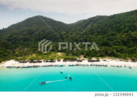 Tourist boats parked along turtle beach, with tourists on Redang Island. Malaysia Tourist boats parked along turtle beach, with tourists on Redang Island. Malaysia 132346641