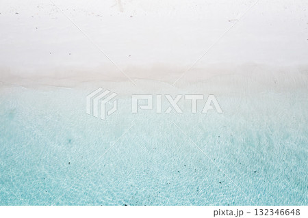 tropical beach, top view of the turquoise sea beautifully spreading on the white sand at the beach in Malaysia. Beautiful waves of seawater rush onto the beach tropical beach, top view of the turquoise sea beautifully spreading on the white sand at the beach in Malaysia. Beautiful waves of seawater rush onto the beach 132346648