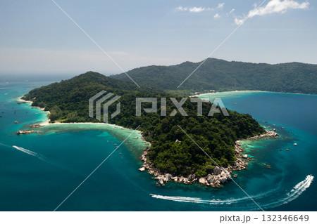 Stunning aerial view of a tropical island with lush greenery and clear waters on a bright sunny day in the Perhentian Islands. Malaysia Stunning aerial view of a tropical island with lush greenery and clear waters on a bright sunny day in the Perhentian Islands. Malaysia 132346649