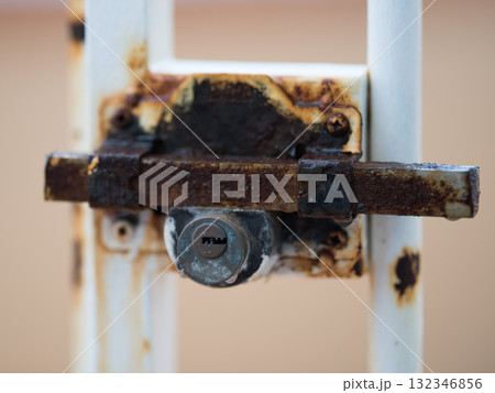 Rusty lock on the door dripping rain 132346856