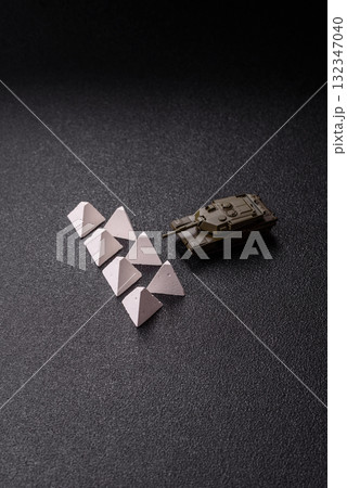 Anti-tank barrier or dragon's teeth made of concrete and iron as a fortification. Dragon's teeth Anti-tank barrier or dragon's teeth made of concrete and iron as a fortification. Dragon's teeth 132347040