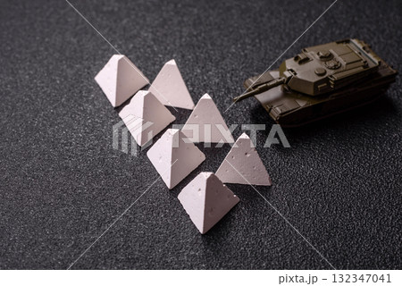 Anti-tank barrier or dragon's teeth made of concrete and iron as a fortification. Dragon's teeth Anti-tank barrier or dragon's teeth made of concrete and iron as a fortification. Dragon's teeth 132347041