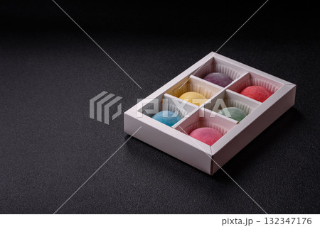 Japanese mochi, ice cream or Asian sweets with fruit filling. Mochi of different colors 132347176