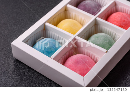 Japanese mochi, ice cream or Asian sweets with fruit filling. Mochi of different colors Japanese mochi, ice cream or Asian sweets with fruit filling. Mochi of different colors 132347180