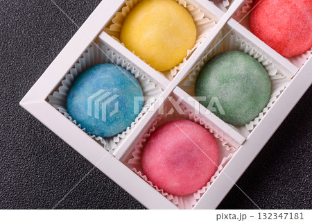 Japanese mochi, ice cream or Asian sweets with fruit filling. Mochi of different colors Japanese mochi, ice cream or Asian sweets with fruit filling. Mochi of different colors 132347181