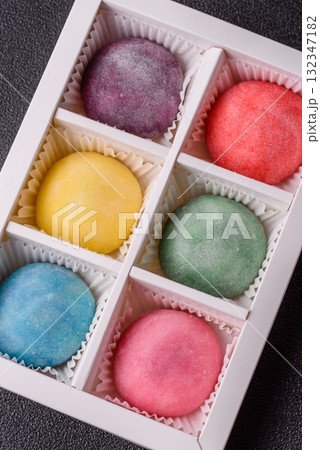 Japanese mochi, ice cream or Asian sweets with fruit filling. Mochi of different colors 132347182