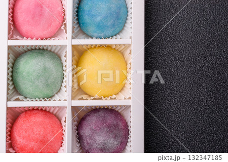 Japanese mochi, ice cream or Asian sweets with fruit filling. Mochi of different colors 132347185