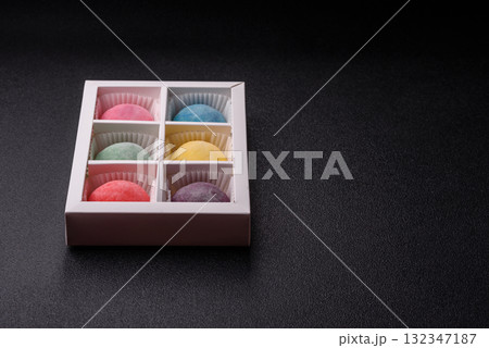 Japanese mochi, ice cream or Asian sweets with fruit filling. Mochi of different colors 132347187