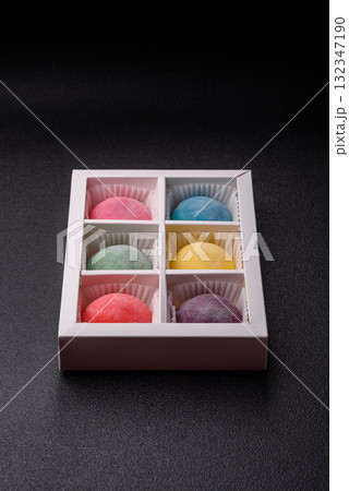 Japanese mochi, ice cream or Asian sweets with fruit filling. Mochi of different colors Japanese mochi, ice cream or Asian sweets with fruit filling. Mochi of different colors 132347190