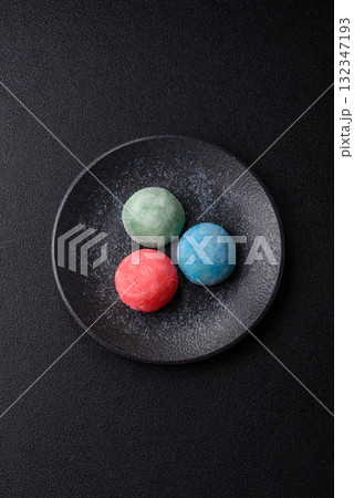 Japanese mochi, ice cream or Asian sweets with fruit filling. Mochi of different colors 132347193