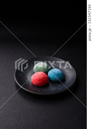 Japanese mochi, ice cream or Asian sweets with fruit filling. Mochi of different colors Japanese mochi, ice cream or Asian sweets with fruit filling. Mochi of different colors 132347194