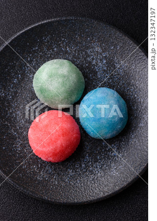 Japanese mochi, ice cream or Asian sweets with fruit filling. Mochi of different colors 132347197