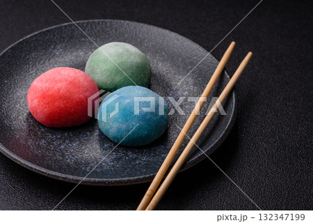 Japanese mochi, ice cream or Asian sweets with fruit filling. Mochi of different colors 132347199