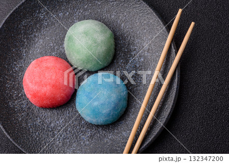 Japanese mochi, ice cream or Asian sweets with fruit filling. Mochi of different colors 132347200