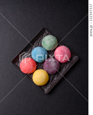 Japanese mochi, ice cream or Asian sweets with fruit filling. Mochi of different colors 132347317