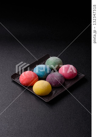 Japanese mochi, ice cream or Asian sweets with fruit filling. Mochi of different colors 132347318